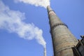 Smoking pipes of power plant against blue sky Royalty Free Stock Photo