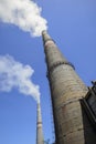 Smoking pipes of power plant against blue sky Royalty Free Stock Photo