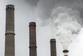 Smoking pipes of thermal power plant with dramatic dark cloudy sky Royalty Free Stock Photo