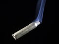 Smoking rifle cartridge on black Royalty Free Stock Photo