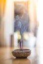 Smoking and smelling joss sticks at home, feng shui; Copy space