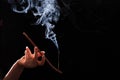 Smoking stick in the woman`s hand