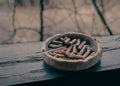 A clay ashtray with butts on a wooden terrace beam Royalty Free Stock Photo