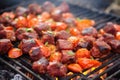 smoky chorizo sausage amidst asado cuts on grill
