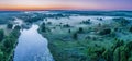 Smoky morning mist over the river. Beautiful panoramic view of river and green banks of the river in the early summer morning Royalty Free Stock Photo