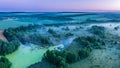 Smoky morning mist over the river. Beautiful panoramic view of river and green banks of the river in the early summer morning Royalty Free Stock Photo
