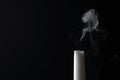 Smoldering candle wick and smoke on dark background Royalty Free Stock Photo