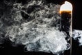 Smoldering cigar with swirling clouds of smoke on a black background.