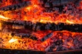 Smoldering embers of fire, live coals, burning charcoal in the background texture, closeup, glowing coal Royalty Free Stock Photo