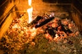 smoldering woods and hot ash in fireplace closeup