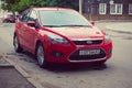 Red Ford Focus parked in street olf old russian city Smolensk.