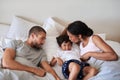 Smooches galore for my little bean. a beautiful young family of three spending time together in their bedroom at home. Royalty Free Stock Photo