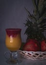 Smoorhie with pineapple and pomegrante with fruit in background Royalty Free Stock Photo
