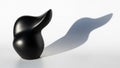 Its curvaceous form casts a distinct shadow on the light surface beneath Royalty Free Stock Photo