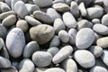 Smooth and beautiful pebbles on the beach in the sunlight close up Royalty Free Stock Photo