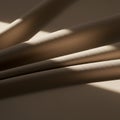 Smooth, beige fabric folds create a play of light and shadow across the surface. Sunlig Royalty Free Stock Photo