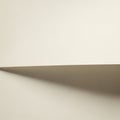 A smooth, beige piece of paper creates a simple composition. A shadow is cast Royalty Free Stock Photo