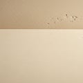 Smooth beige surface meets a textured beige wall with subtle imperfections Royalty Free Stock Photo