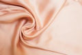 Smooth biege fabric cloth texture with folds and wawes. Close up Abstract background. Biege drapped silk Royalty Free Stock Photo