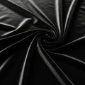 Smooth black fabric arranged in a spiral pattern, creating eleg Royalty Free Stock Photo