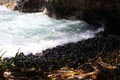 Smooth, black rocky shoreline at Onomea Bay in Papaikou, Hawaii Royalty Free Stock Photo