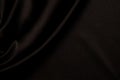 Smooth black satin silk fabric with subtle draperies. Top view Royalty Free Stock Photo