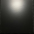 Smooth black slate surface with subtle textured lines. The material appears solid and Royalty Free Stock Photo