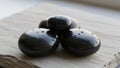 Smooth black stones with water droplets are arranged on a textured, light-colored surface. The Royalty Free Stock Photo