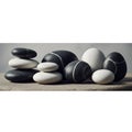Smooth black and white stones arranged on a flat surface. The stones vary in size, Royalty Free Stock Photo