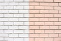 Smooth brick wall. White and pink paint. Same bricks Royalty Free Stock Photo