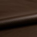Smooth brown leather with a rich texture, rolled and displayed diagonally. The surface Royalty Free Stock Photo