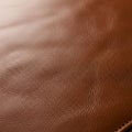 Smooth brown leather texture with a fine grain pattern, showcasing subtle natural Royalty Free Stock Photo