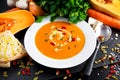 Smooth butternut squash and carrot soup with cream, pumpkin seeds goji berries
