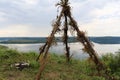 A smooth calm water view. A tent made of twigs on the banks of a large river. Royalty Free Stock Photo
