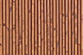 Smooth dark brown boards with knots. Surface texture of wooden slats. Background of polished wood strips Royalty Free Stock Photo