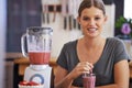 Smooth and delicious. Portrait of an attractive young woman enjoying a fruit smoothie she made.