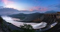 Smooth draining water from the hydroelectric dam at dawn