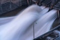 Smooth draining water from the hydroelectric dam at dawn Royalty Free Stock Photo