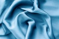 Smooth elegant blue silk fabric surface close up texture background