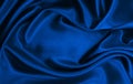 Smooth elegant blue silk or satin luxury cloth texture as abstract background. Luxurious Christmas background or New Year