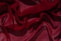 Smooth elegant burgundy chiffon fabric abstract background. Dark red wine silk luxury cloth texture light surface design Royalty Free Stock Photo