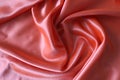 Smooth elegant coral silk or satin fabric. Draped luxury cloth texture for design. Close-up