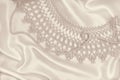 Smooth elegant golden silk or satin with pearls and lace as wedding background. In Sepia toned. Retro style Royalty Free Stock Photo