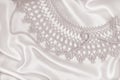 Smooth elegant golden silk or satin with pearls and lace as wedding background. In Sepia toned. Retro style Royalty Free Stock Photo