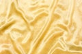 Golden silk fabric or satin texture. Smooth elegant and luxury fabric background with copy space. Royalty Free Stock Photo