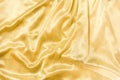 Golden silk fabric or satin texture. Smooth elegant and luxury fabric background with copy space. Royalty Free Stock Photo