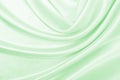 Smooth elegant green silk or satin luxury cloth texture as abstract background. Luxurious background design