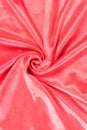 Luxury red or rose silk background. Rippled silk fabric, drapery cloth, or satin texture Royalty Free Stock Photo