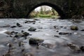 Smooth flowing stream beneath a bridge. Pendleton brook in Clitheroe, Ribble valley