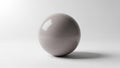A smooth glossy gray sphere is centrally positioned against a plain white Royalty Free Stock Photo